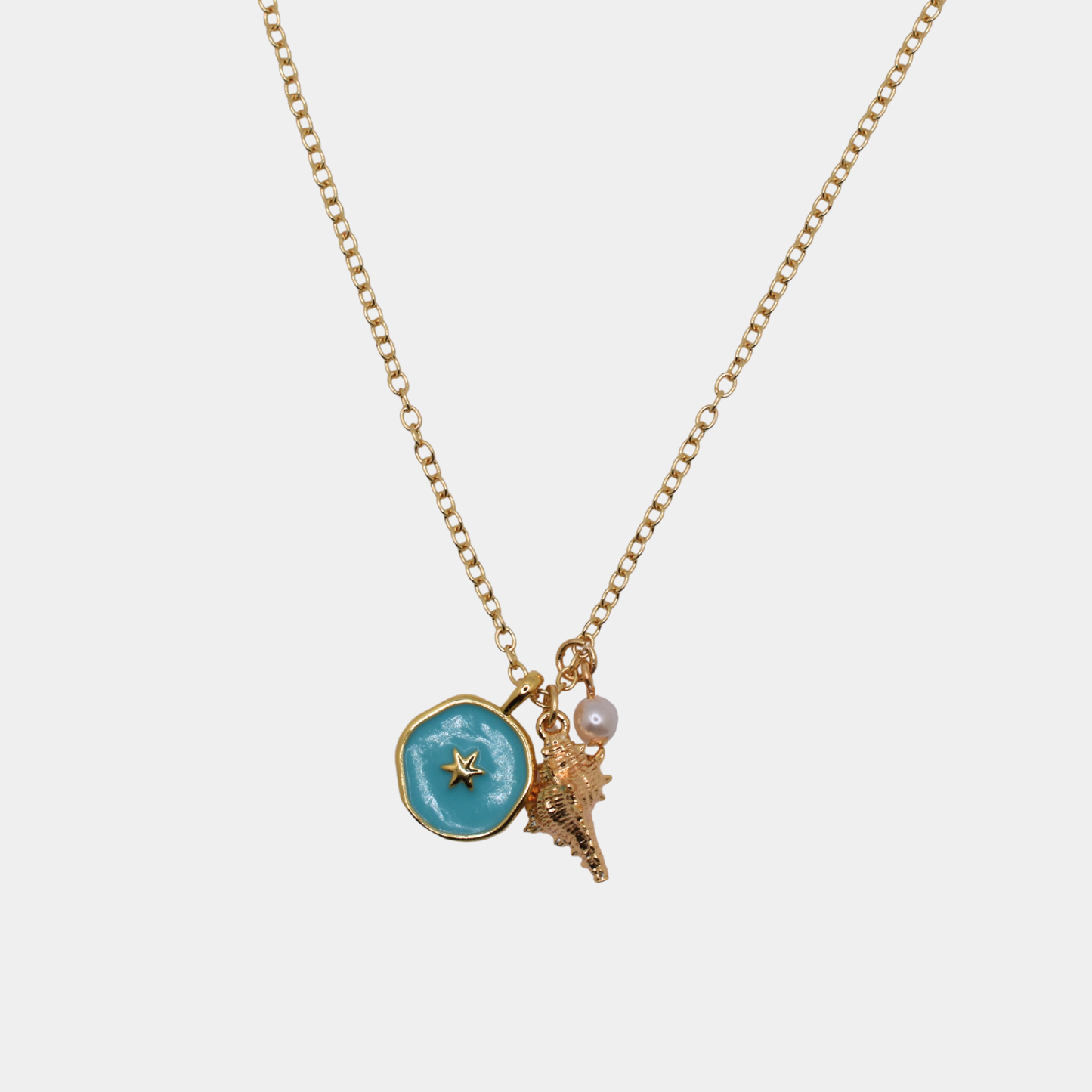 Necklace with blue pendant, star, shell, and pearl on a white background